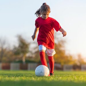 Young girl playing soccer