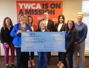 YWCA Cass Clay team holding a check